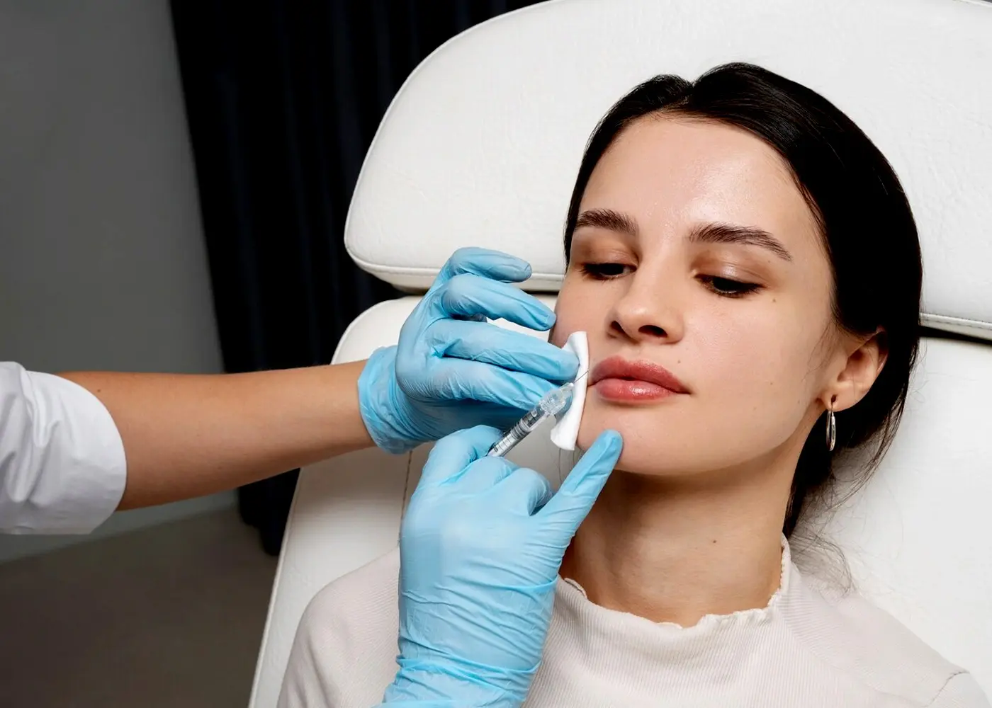 A woman receiving a filler injection, focusing on enhancing natural beauty.